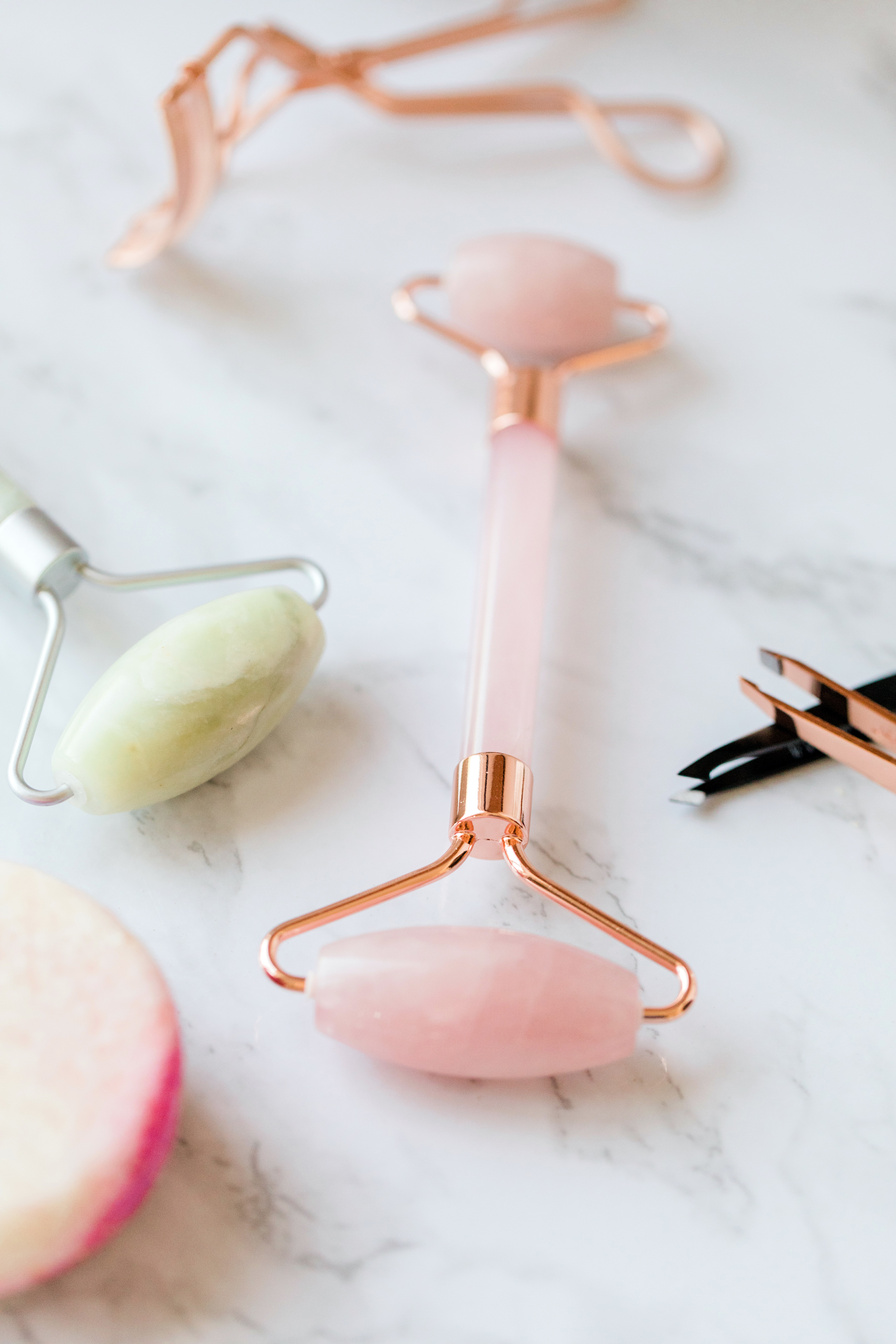 Jade Rollers on Marble Background